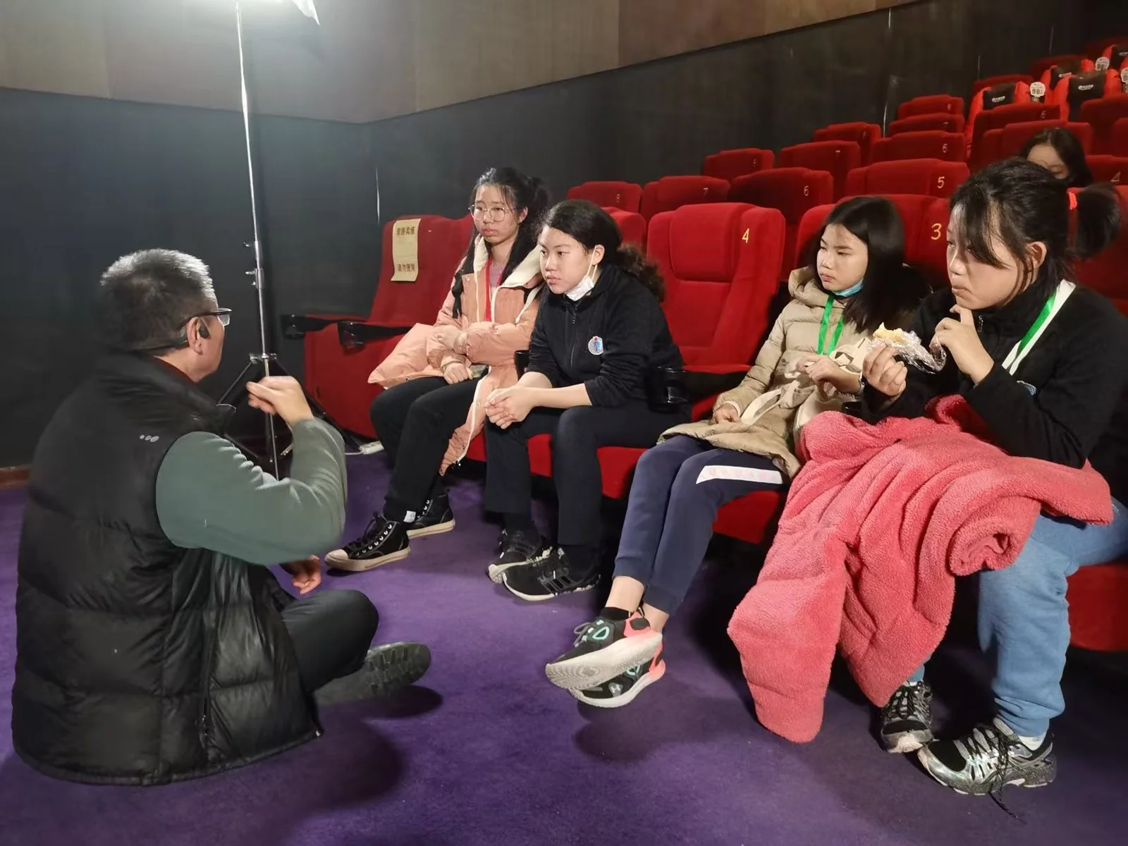 Liya and fellow volunteers talking with a cinema visitor before a screening