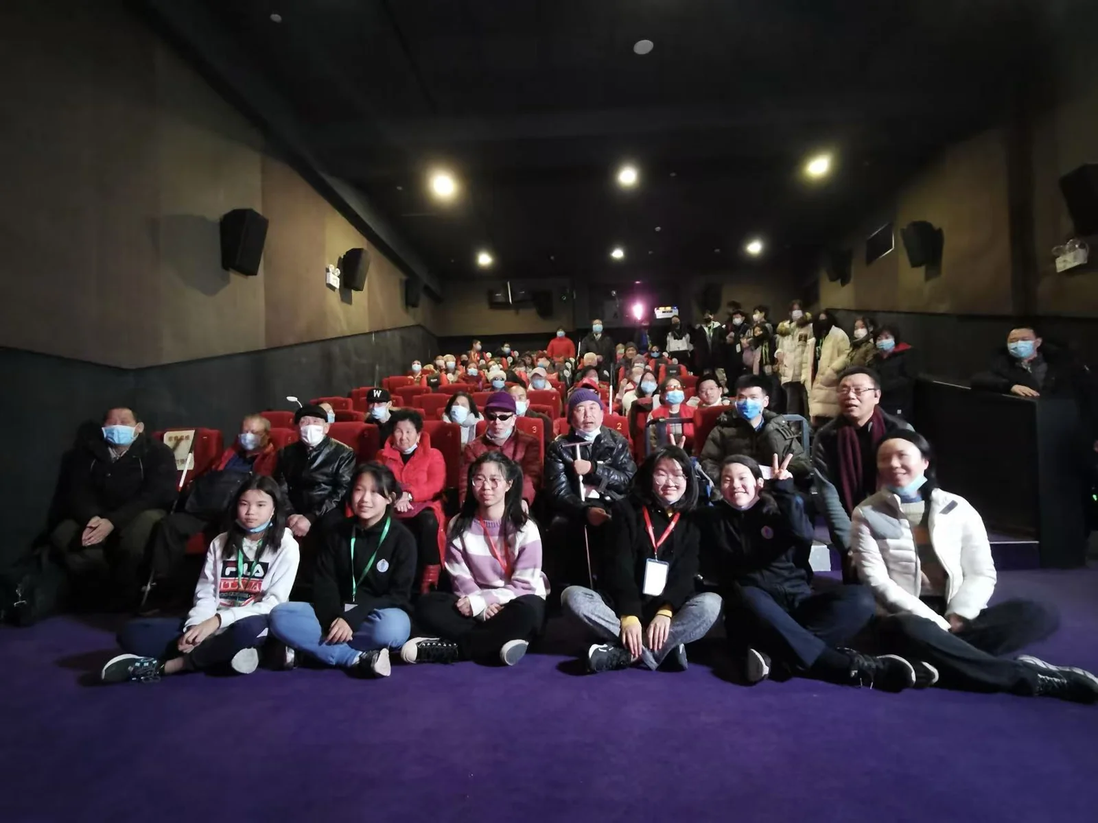Volunteers and cinema visitors gathered together for a group photo