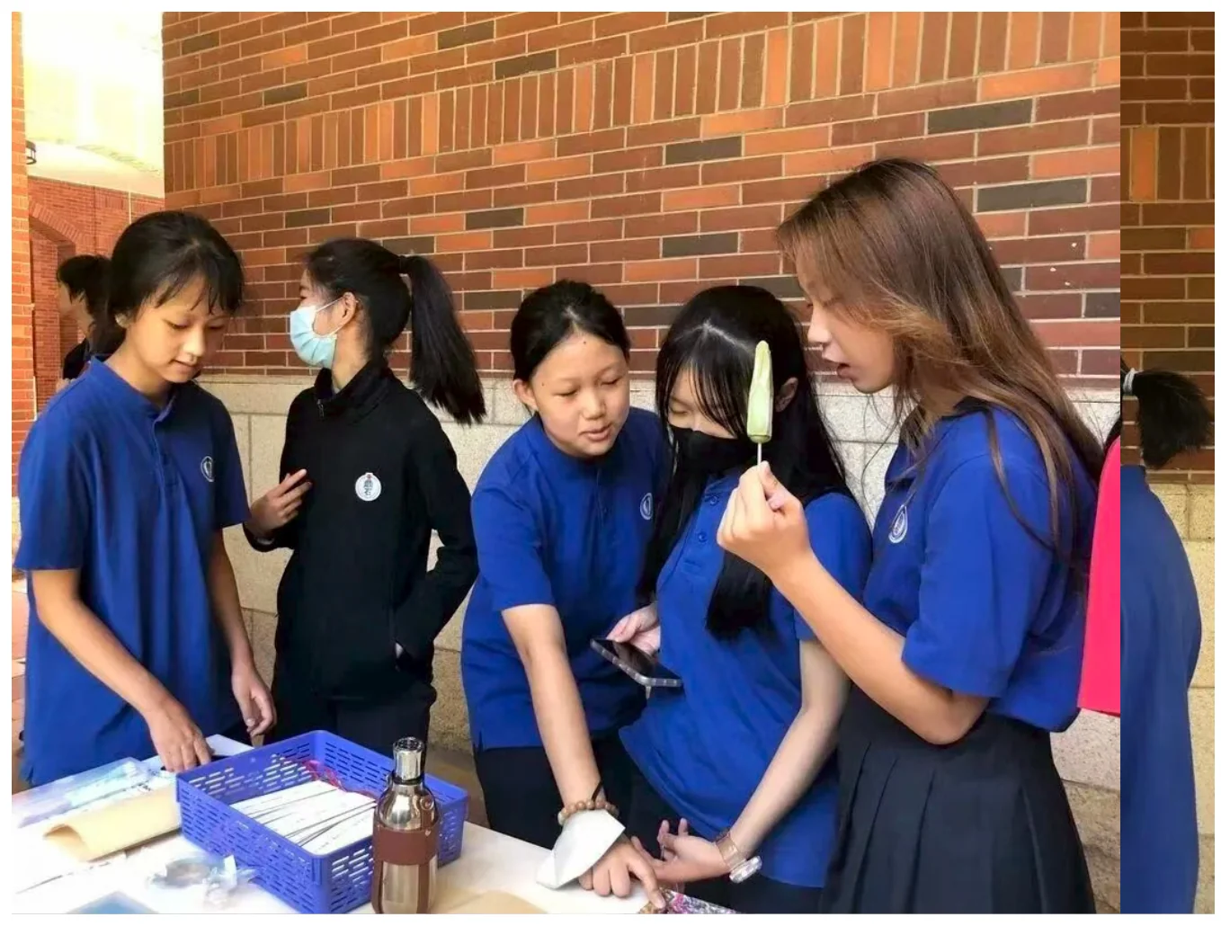 Liya and students discussing a community project at a school service fair